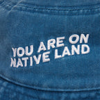 'YOU ARE ON NATIVE LAND' BUCKET HAT by Urban Native Era